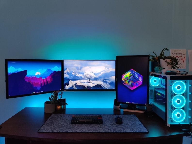 Monitors and gaming computer at a desk.