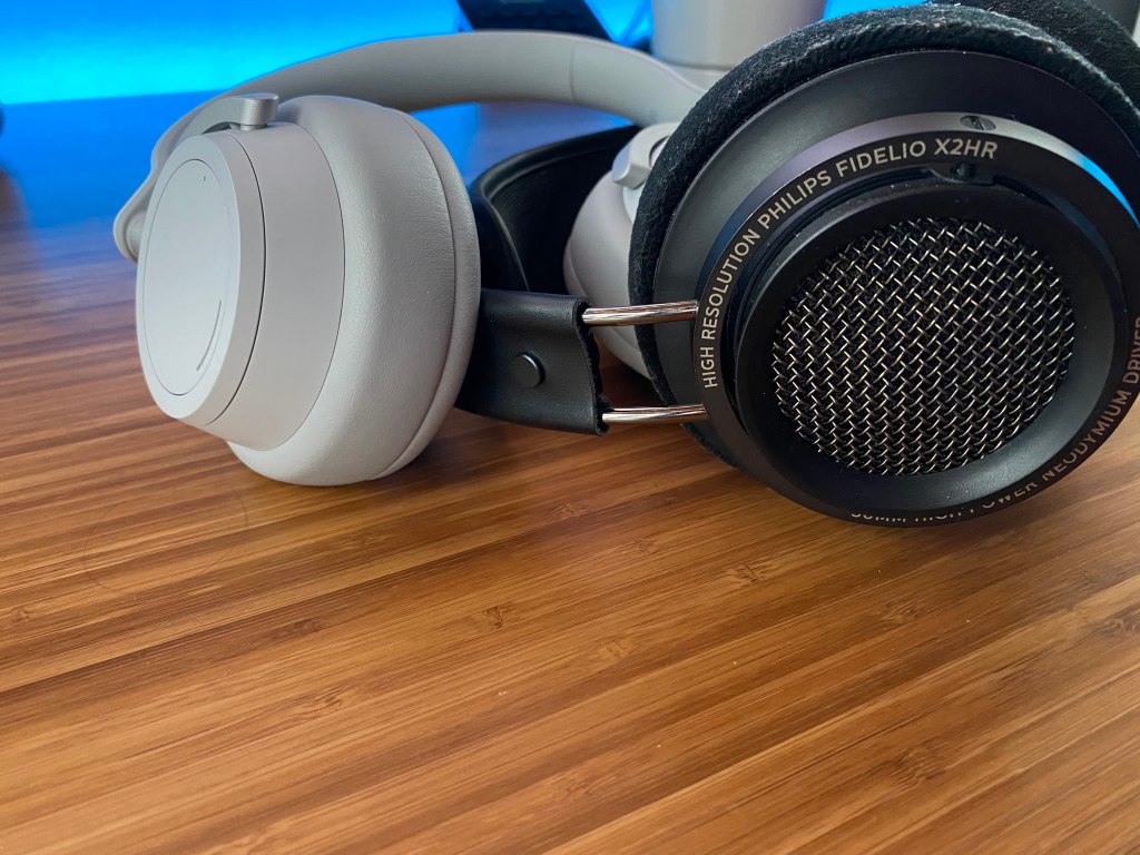 Closed back and open back headphones on a desk