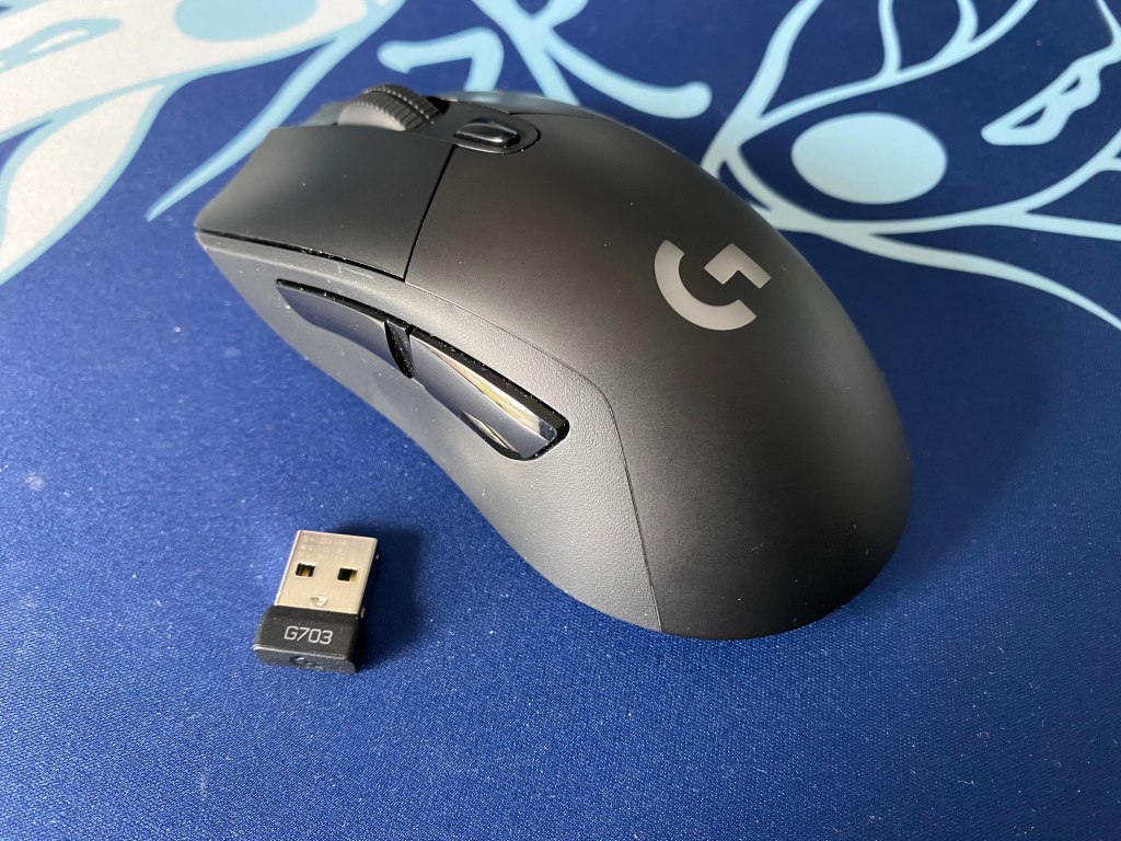 Angled view of Logitech G703 with wireless adapter