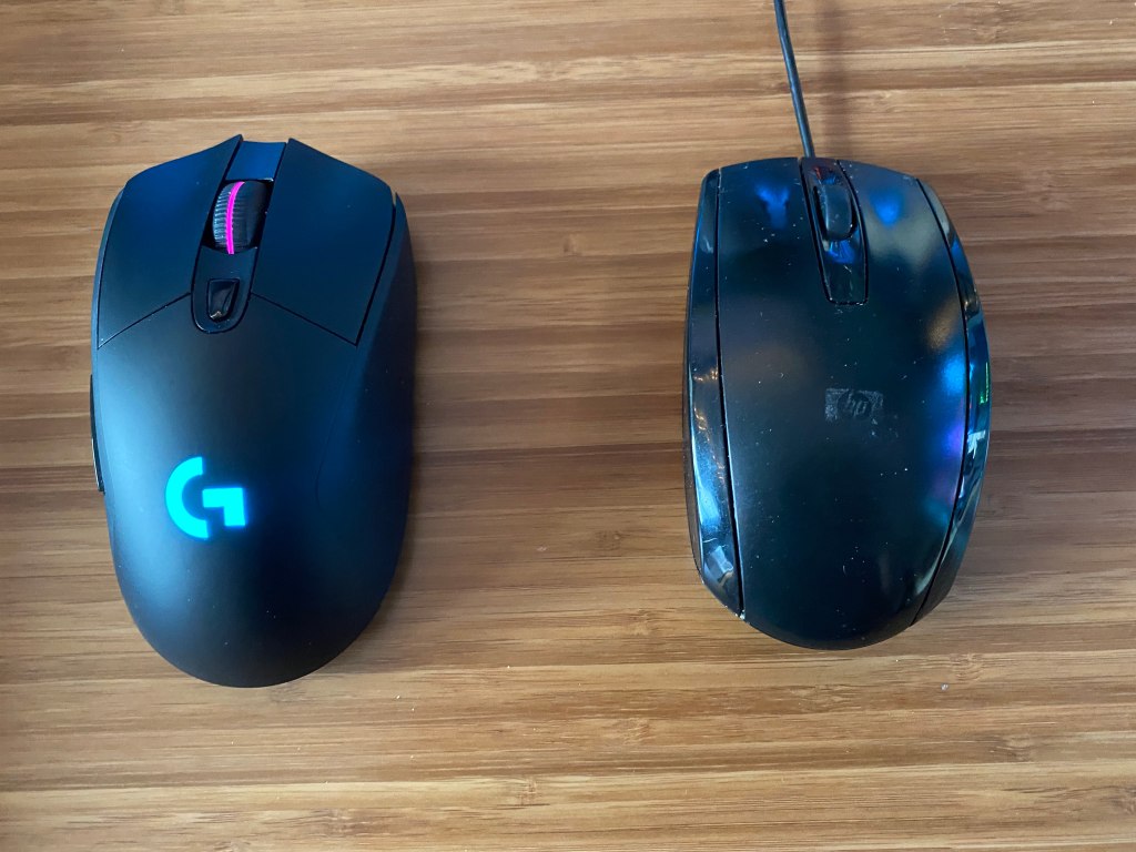Top view of Logitech G703 gaming mouse next to regular mouse.
