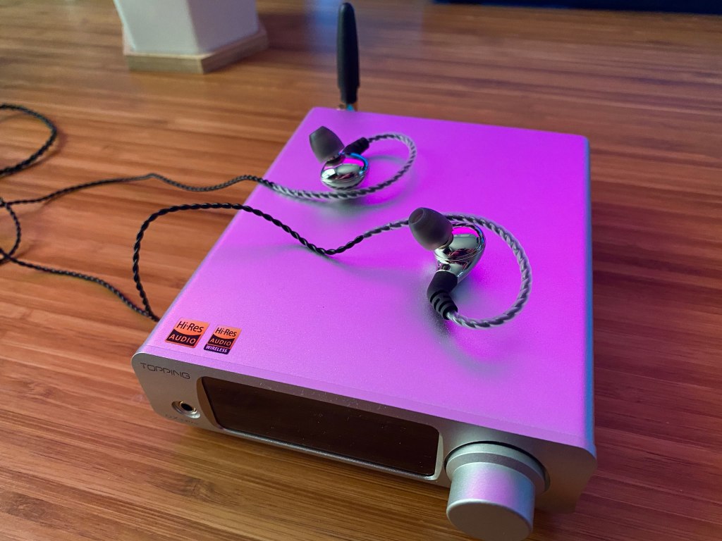 A headphones amp with some IEMs on top.