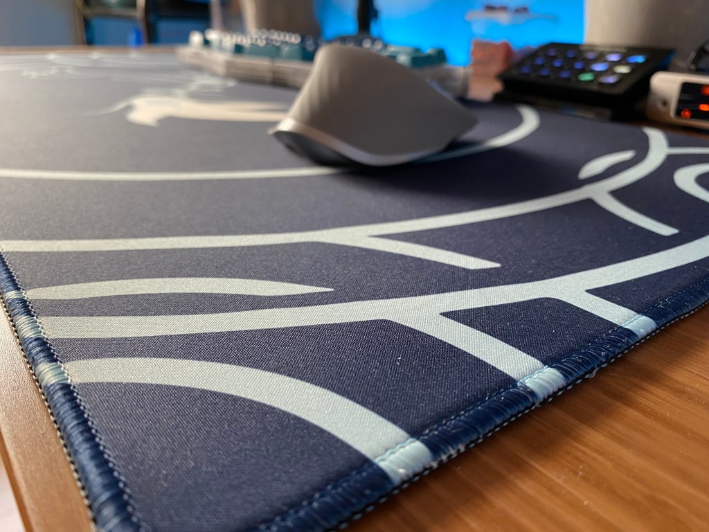 Close up of a deskpad at a PC setup.