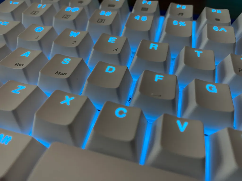 Close up of Royal Kludge RK96 mechanical keyboard with RGB lighting enabled.
